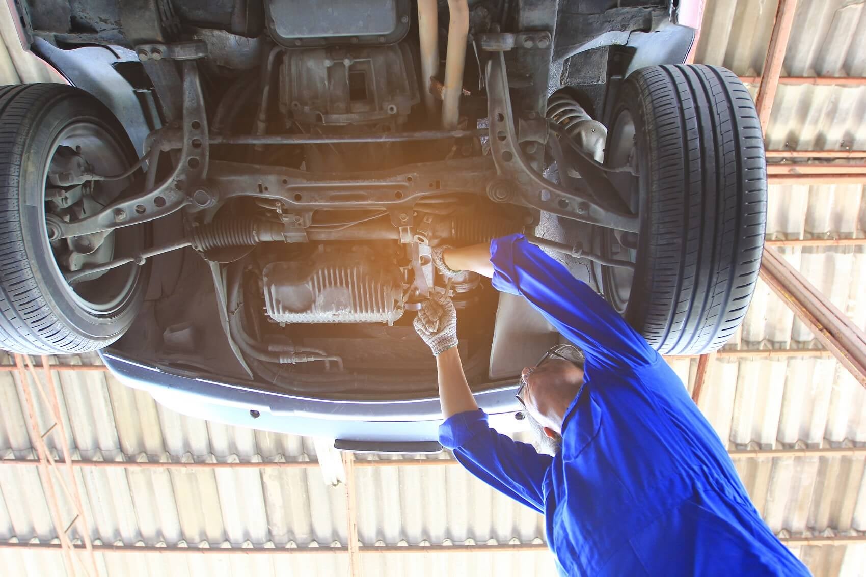 Technician working on a transmission at Atlantic INFINITI