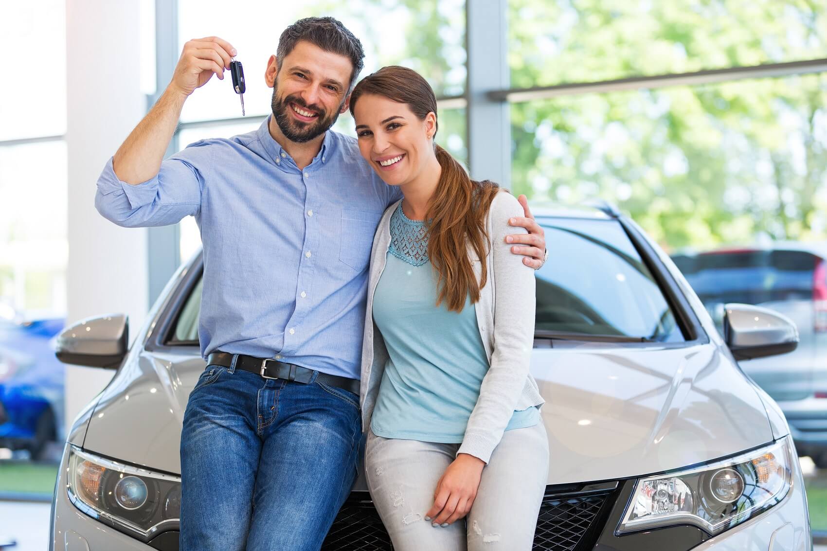 Happy couple smiling holding car keys
